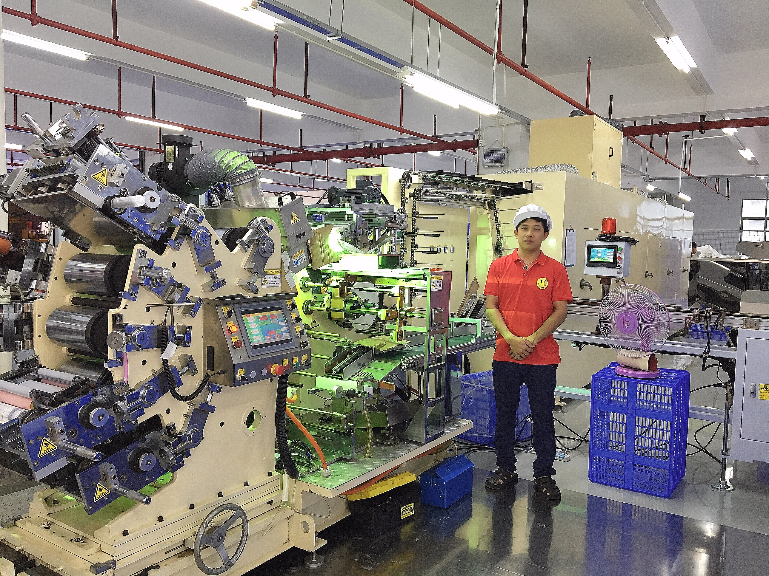 Company employees taking a group photo with machines